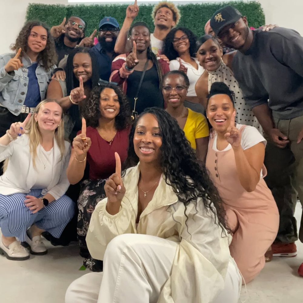 A group from the church smiling together, each holding up one finger